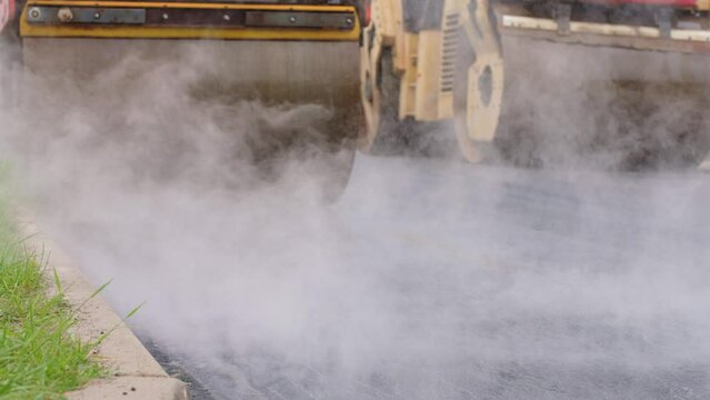 Machine is laying new layer of asphalt, construction of a new pavement