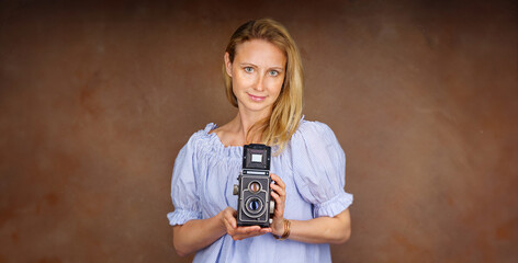  Attractive Woman taking photo with old professional medium format camera