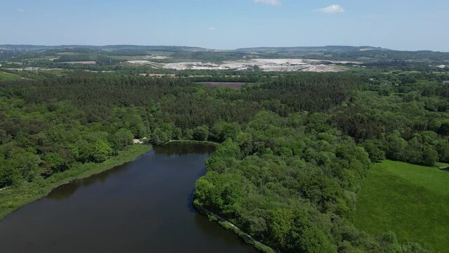 Stover Country Park, South Devon, England: DRONE AERIAL VIEWS: Devon hills, clay quarries, dense woodland and Stover Lake (Clip 2).