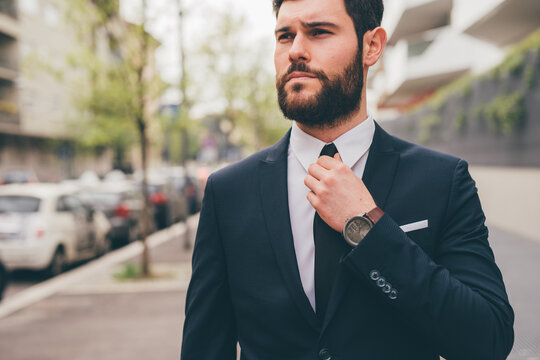 Young elegant professional executive bearded businessman posing