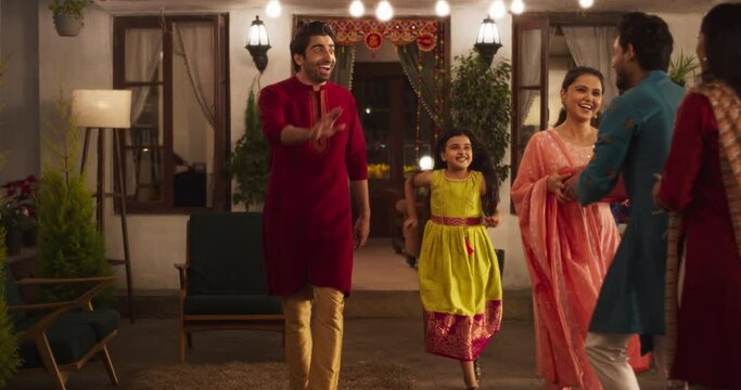 Authentic Shot of Indian Family Receiving Family Over as Guests. Genuine Happiness in a Reunion Between Friends to Celebrate Diwali Together. Young Parents and Kids Happily Greeting. Zoom Out