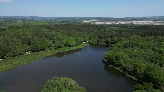Stover Country Park, South Devon, England: DRONE AERIAL VIEWS: Devon hills, clay quarries, dense woodland and Stover Lake (Clip 1)