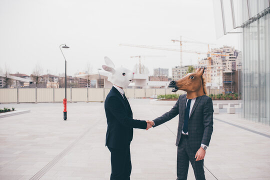 Business handshake in front of high office building