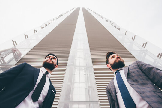 Low angle view of two contemporary caucasian bearded businessmen