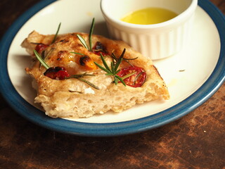 slice of Focaccia bread with tomato and rosemary