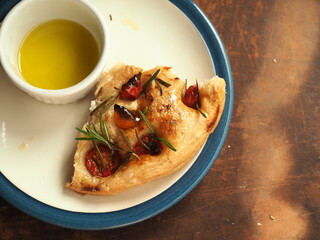 Slice of Focaccia with rosemary, tomato and olive oil
