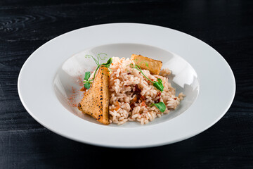 Fried white fish with rice, peppers, tomatoes and herbs.