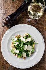 Green salad with parmesan cheese, arugula, mushrooms, asparagus and olive oil.