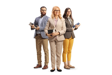 Fototapeta premium Team of teachers holding books and posing