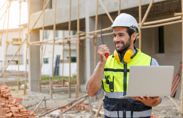 Young architect engineering consultant using laptop on construction site inspecting building, inspecting, designing and planning