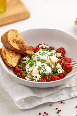 Portion of gourmet breakfast with poached eggs and tomatoes
