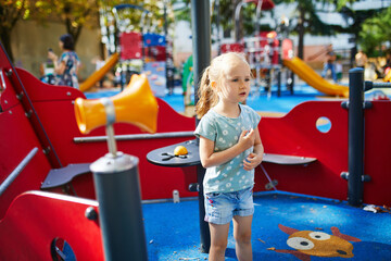 Fototapeta na wymiar Adorable little girl on playground on a sunny day