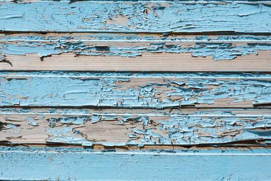 wall of old wooden house with blue cracked paint, free space for design