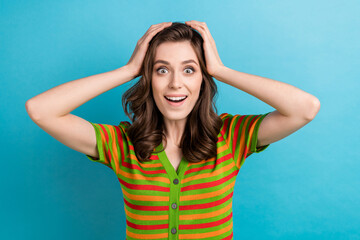 Closeup portrait of funny girl brown curls hands head speechless staring you look like lottery winner isolated on blue color background