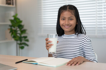 children women drink milk to nourish the body and nourish the brain. asian young little girl learn...