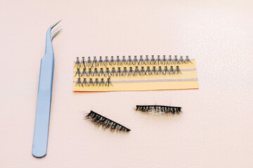 Artificial false fluffy eyelashes with tweezers.