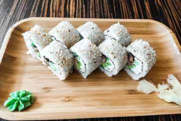Rolls with tuna, avocado and nori close-up.