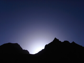 Sunrise on a blue mountain silhouette background