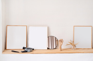 set of empty wooden photo frames for mockup design on the wooden shelf