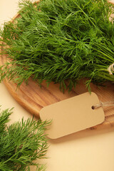 Bunch of dill with inscription on beige background. Top view. Food for vegetarians