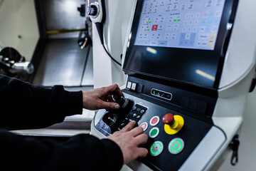 Close up man hand operating with CNC machine.