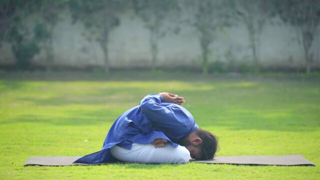 Young Indian man doing yoga in morning