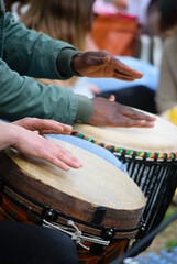 Drummer hands playing the ethnic djembe drum.