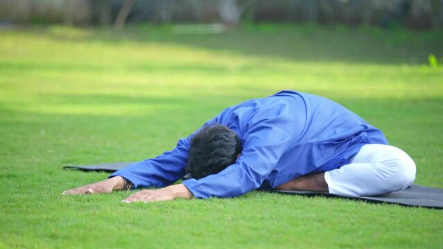 Indian man performing advanced yoga