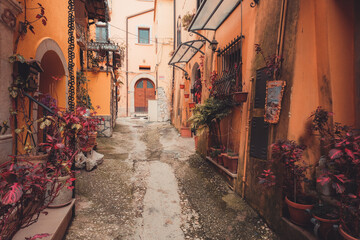 Fototapeta na wymiar Narrow street with flower pots of the town of Venafro, Molise Italy