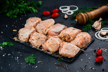 Portion raw chicken thighs for barbecue with sauce and spices.