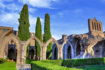 Gordijnen Bellapais Abbey, or "the Abbey of Peace" , is the ruin of a monastery built by Cannons Regular in the 13th century on the northern side of the small village of Bellapais, now in Northern Cyprus. © Kyrenian