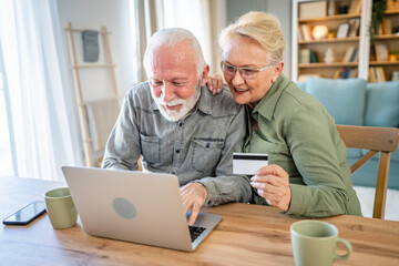 Senior couple husband and wife hold credit card online shopping