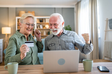Fototapeta premium Senior couple husband and wife hold credit card online shopping