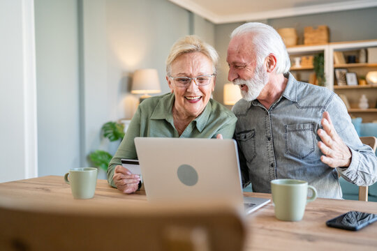 Senior couple husband and wife hold credit card online shopping