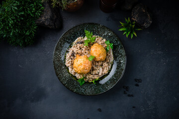 Dinner chicken meatballs with barley porridge, mushrooms, sauce and herbs.