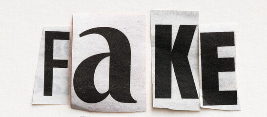 FAKE word arranged from newspaper clippings.