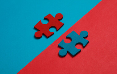 Blue and red jigsaw puzzle pieces on blue red background. Conceptual business photo