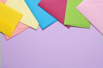 Set of colored envelopes on lavender color background. Copy space