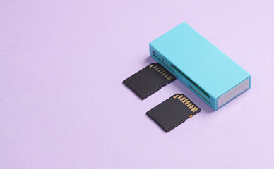 Card reader with two sd memory cards on a pastel purple background