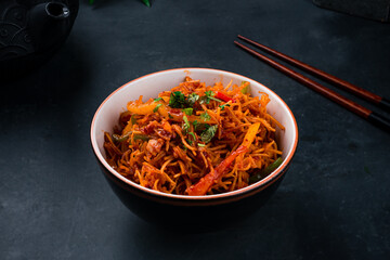 Fried noodles with chicken, sweet peppers, onions, green beans, sauce and herbs.