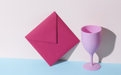 Plastic goblet with envelope on pastel background. Minimal, creative layout