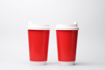 Fototapeta na wymiar Take-out red cardboard coffee cups with lid on white background