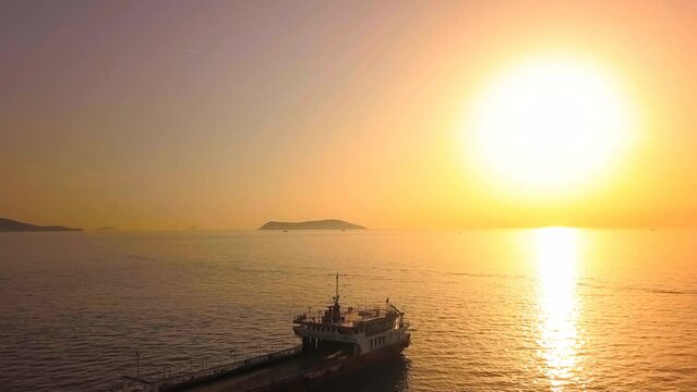 Landing craft and the sun. Aerial shot of bulk carrier ship anchored 600 meters off the coast of Maltepe Region in Istanbul. 
