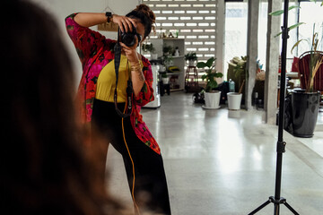 Plus sized female getting her headshots taken by a south asian female photographer