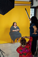 Plus sized female getting her headshots taken by a south asian female photographer