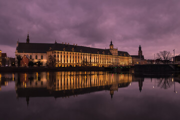 Wroclaw University building with reflection in the river. - 606114845