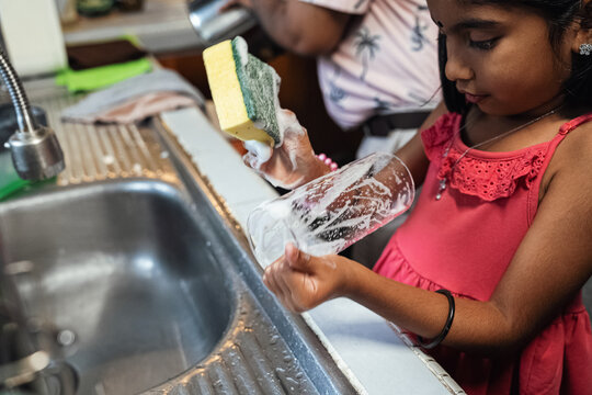 Children helping their parents wash up after dinner