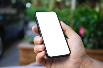 Man hands hold phone with isolated screen background green street.