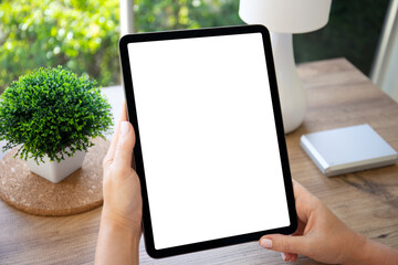 female hands hold computer tablet with isolated screen background table