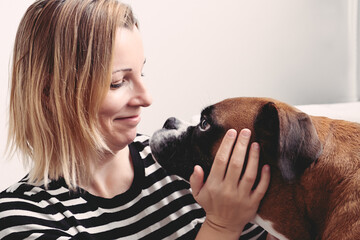 Love between boxer dog and mom woman